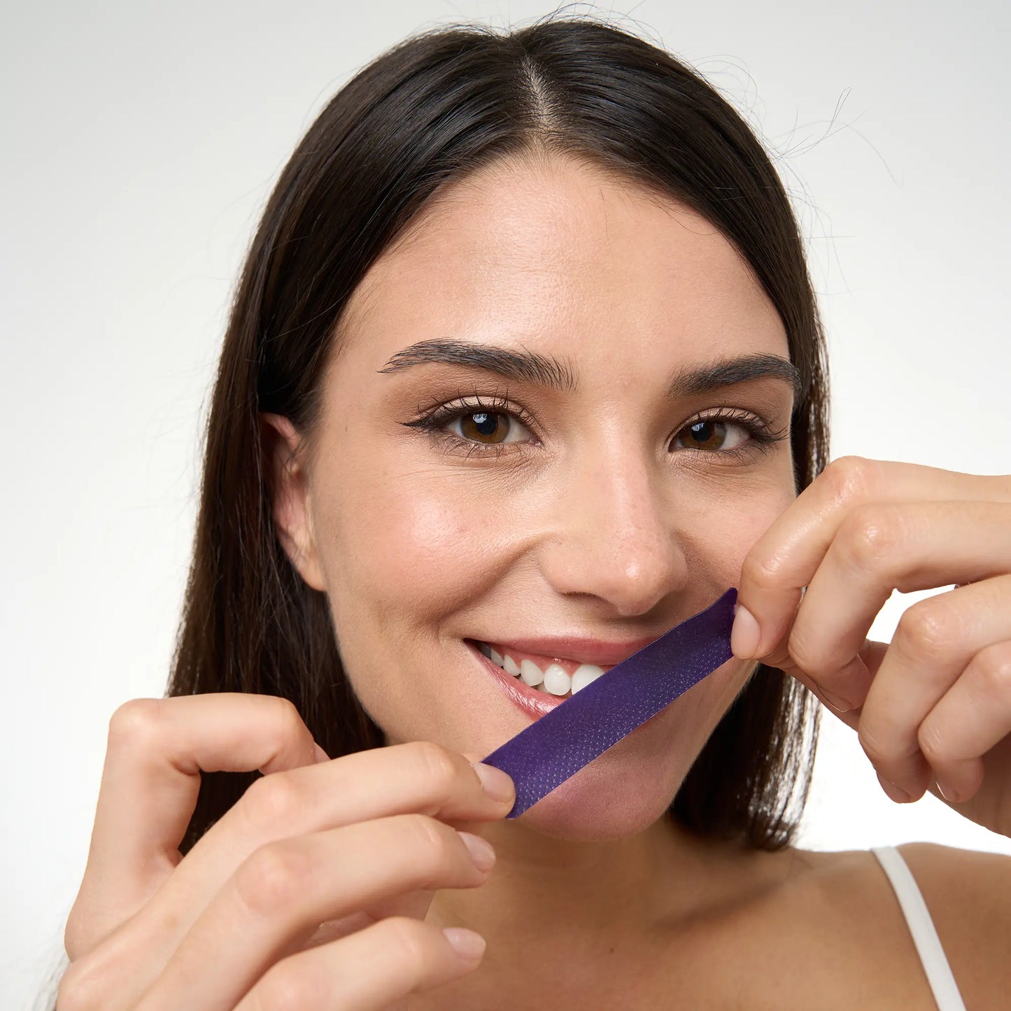 Purple teeth whitening strips package and treatment strips